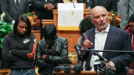 KAITLIN NEWMAN. Freddie Gray's family stand behind Billy Murphy, their lawyer, as he speaks about the charges of the six police officers that were in charge of Gray when he died.