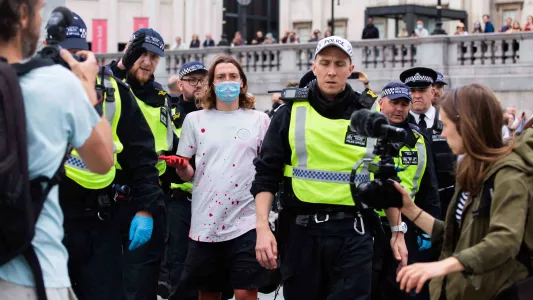 sam davis. Animal and climate justice activist being arrested after protesting in fountain at Trafalgar Square, London 2020