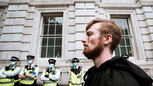 sam davis. Animal Rebellion protestor standing at entrance to Downing Street, London 2020