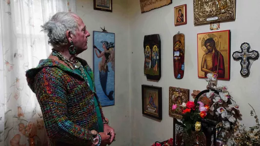 CHIARA FABBRO: Dimitri proudly looking at the religious icons she had covered the wall of her bedroom with.